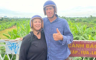 Couple on Vespa tour in Hanoi countryside near Bat Trang Ceramic Village.