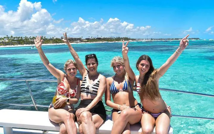 Group enjoying Punta Cana party boat cruise with clear ocean view.