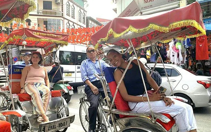 Cyclo riders in Hanoi's Old Quarter during a street food tour.