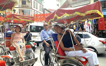 Cyclo riders in Hanoi's Old Quarter during a street food tour.