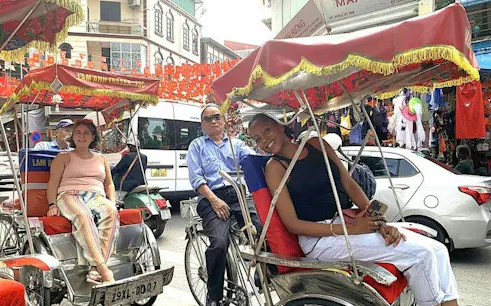Cyclo riders in Hanoi's Old Quarter during a street food tour.