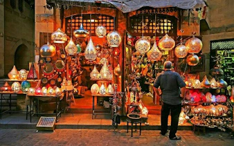 Market stall with traditional lamps in Hurghada bazaar during private guided tour.