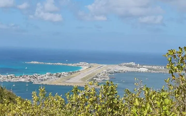 St. Maarten airport runway view from island's highest point during guided hike.