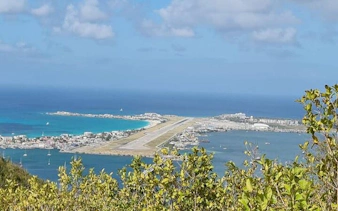 St. Maarten airport runway view from island's highest point during guided hike.
