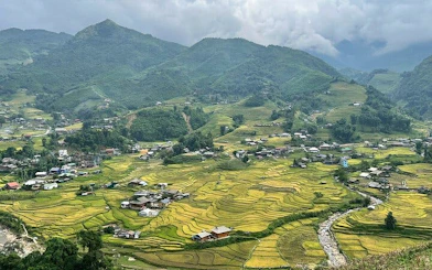 Sapa rice terraces and village with mountains in the background, Vietnam trekking tour.