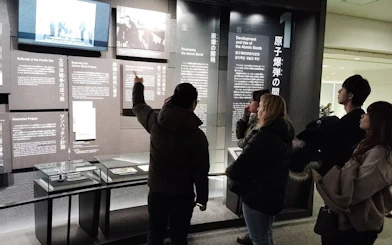 Visitors observing exhibits at Hiroshima Peace Memorial Museum.