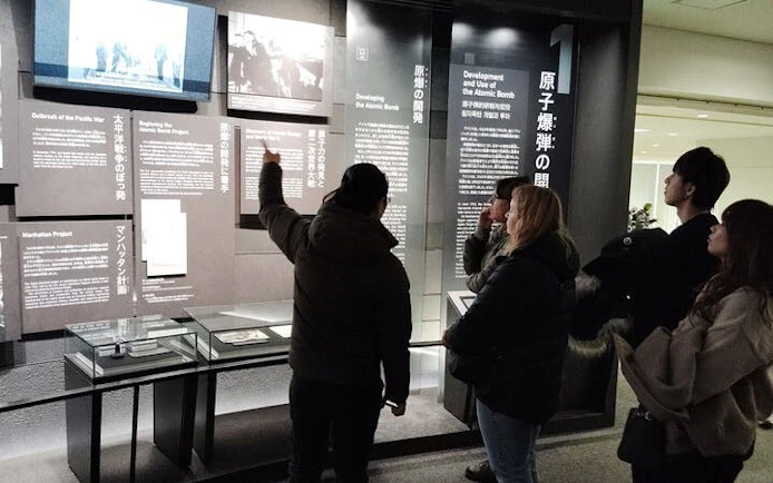 Visitors observing exhibits at Hiroshima Peace Memorial Museum.