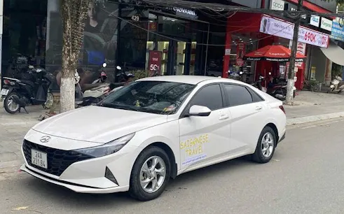 Private car for transfer from Mu Cang Chai to Sa Pa parked on a street.