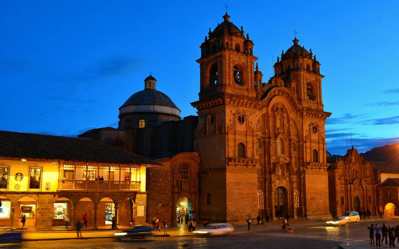 Cusco Historic Center at dusk with illuminated colonial architecture, Peru.