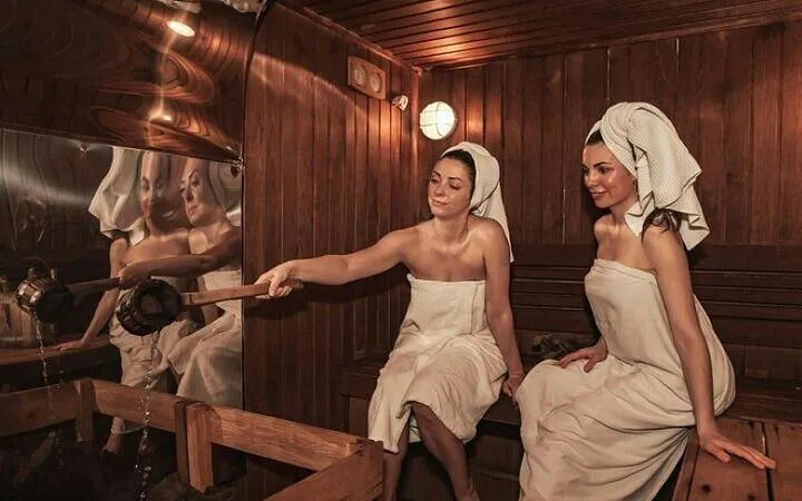 Women enjoying a traditional Moroccan hammam in Marrakesh spa setting.