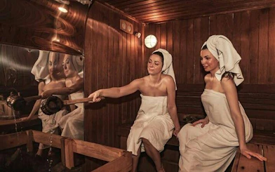 Women enjoying a traditional Moroccan hammam in Marrakesh spa setting.