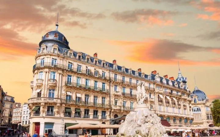 Montpellier historic building and fountain at sunset on self-guided walking tour.