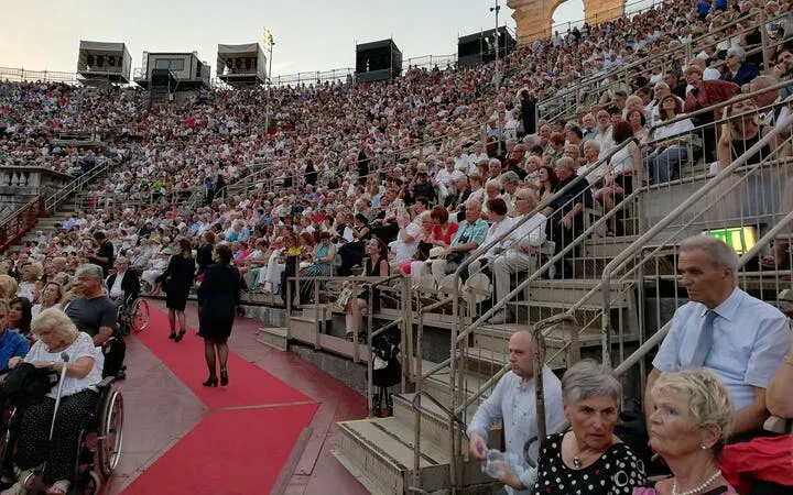 Crowd seated at Arena di Verona for an opera performance, Italy.