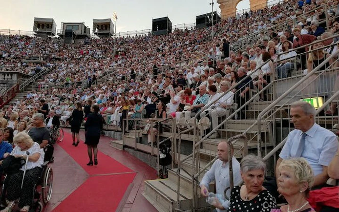 Crowd seated at Arena di Verona for an opera performance, Italy.
