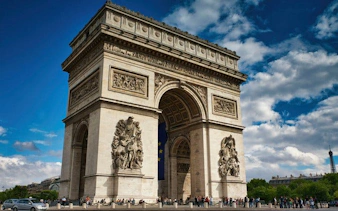 Arc de Triomphe with visitors, Paris skyline visible, rooftop access tour.