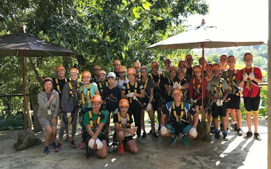 Group of people in harnesses at Phoenix Zipline Adventure Park, Chiang Mai.