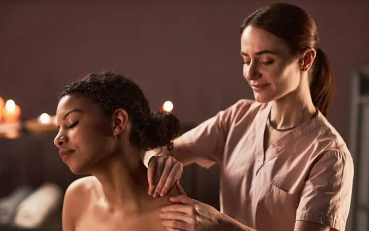 Massage therapist performing shoulder massage at VIP Cleopatra Hamam Bath, Hurghada.