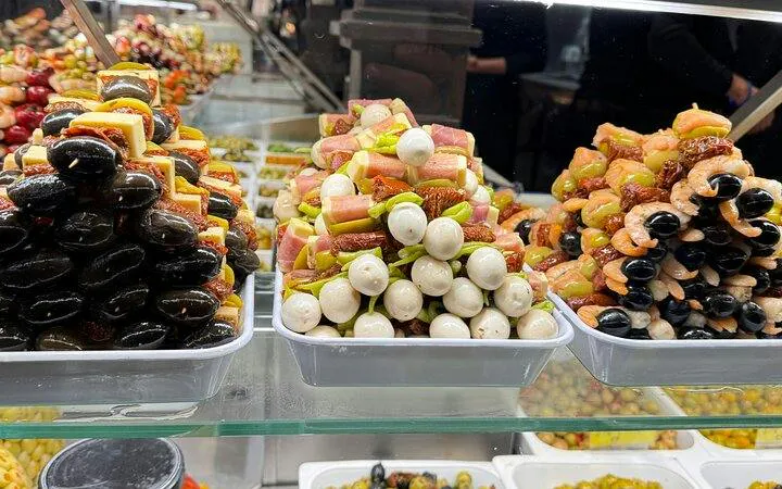 Tapas skewers display in Madrid market during Old Town and Literary Quarter walking tour.