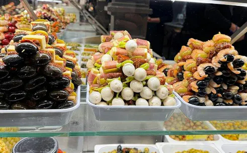 Tapas skewers display in Madrid market during Old Town and Literary Quarter walking tour.