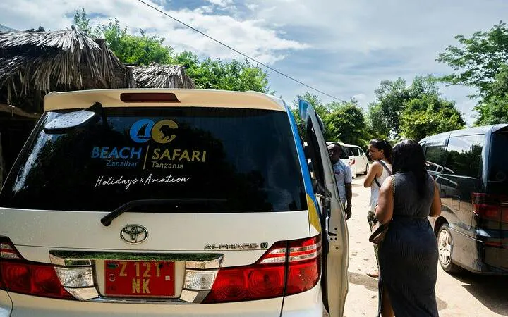 Tourists boarding a van for Stone Town Zanzibar night food market tour with hotel transfers.