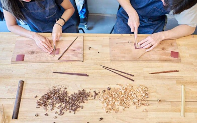Chopstick-making workshop in Arashiyama, Kyoto with participants crafting wooden chopsticks.