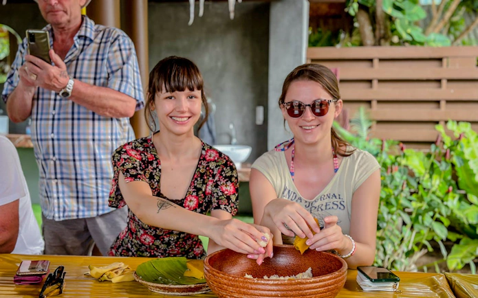 Visitors preparing food for elephants at Samui Elephant Home Nursery.