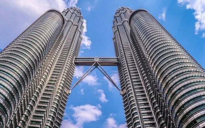 Petronas Twin Towers in Kuala Lumpur against a blue sky.