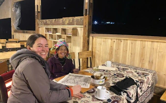 Batik painting session with Hmong artisans at a table in Ta Van workshop.