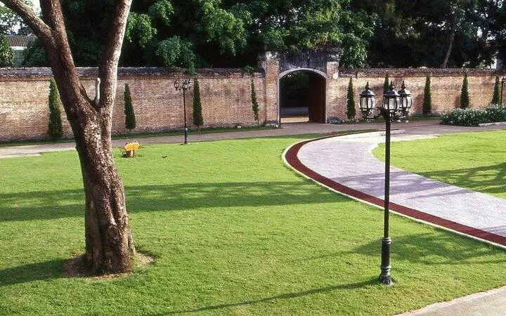 Pathway leading to historic gate in Chiang Rai City tour.