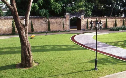 Pathway leading to historic gate in Chiang Rai City tour.