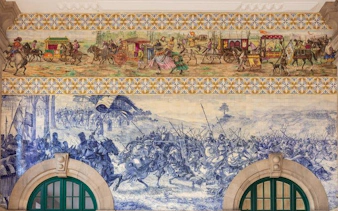 Azulejo tiles depicting historical scenes at São Bento Station, Porto.