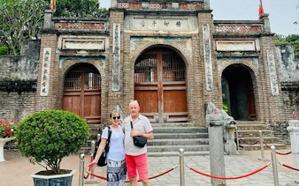 Visitors at Co Loa Citadel entrance, Hanoi, during Vespa tour.