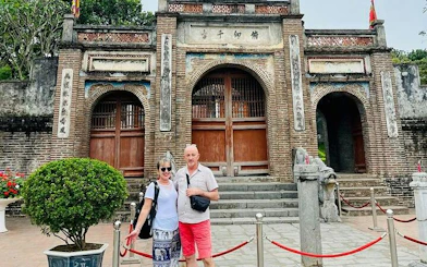 Visitors at Co Loa Citadel entrance, Hanoi, during Vespa tour.