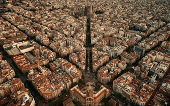 Aerial view of Barcelona cityscape featuring Sagrada Familia, part of self-guided walking tour.