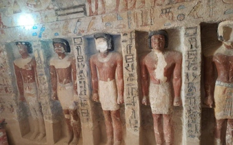 Ancient Egyptian statues with hieroglyphics in a model village, Egypt tour.