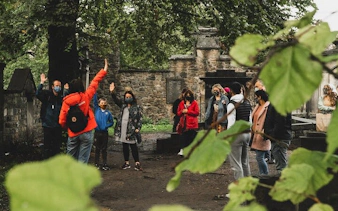 Group on Edinburgh Harry Potter walking tour in a historic graveyard.