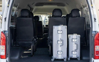 Private car interior with luggage for Tokyo airport transfer.