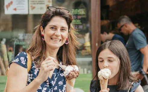 Adults and children enjoying gelato near Guggenheim Museum Bilbao.
