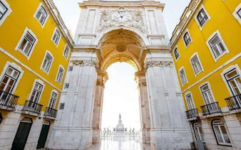 Lisbon's Rua Augusta Arch with yellow buildings on a self-guided walking tour.
