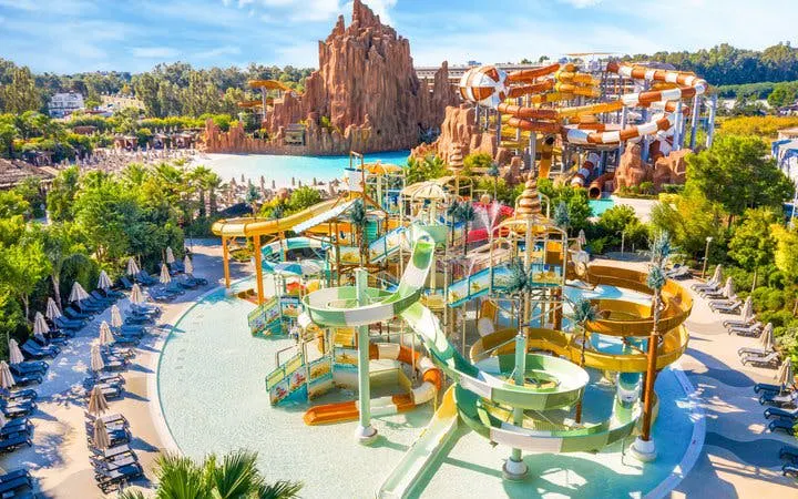 The Land of Legends Theme Park water slides and pools with surrounding lounge chairs.