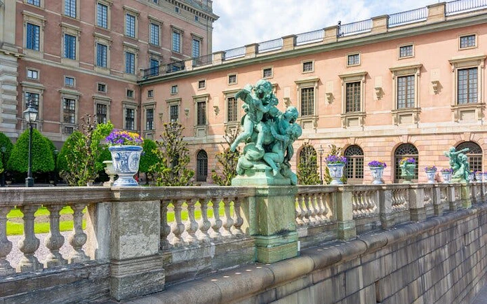 Royal Palace courtyard with statues and ornate balustrade in Stockholm.