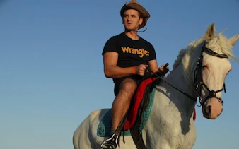 Horseback rider on a white horse at Red Sea beach, Hurghada.