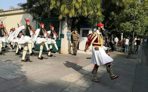 Evzones guards marching in traditional attire during Athens City Highlights Walking Tour.