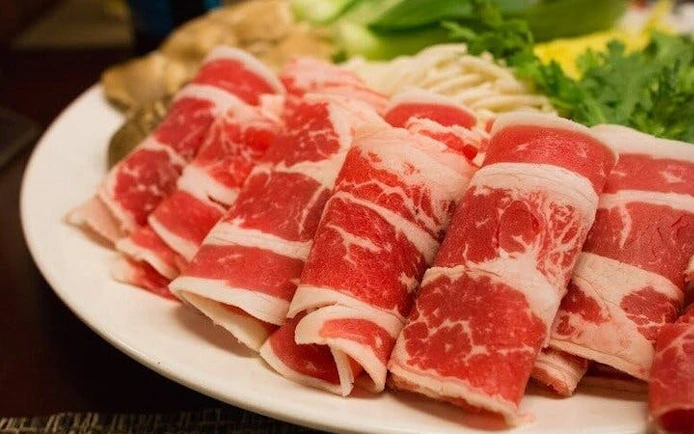 Sliced meat for hotpot meal on Sapa guided local market tour.