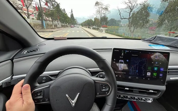 Private car interior on route from Sapa to Ha Giang City with local driver insights.