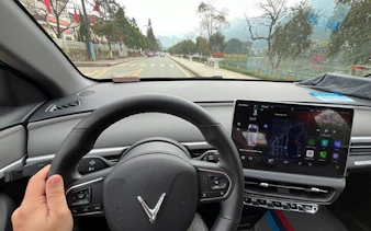 Private car interior on route from Sapa to Ha Giang City with local driver insights.