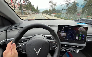 Private car interior on route from Sapa to Ha Giang City with local driver insights.