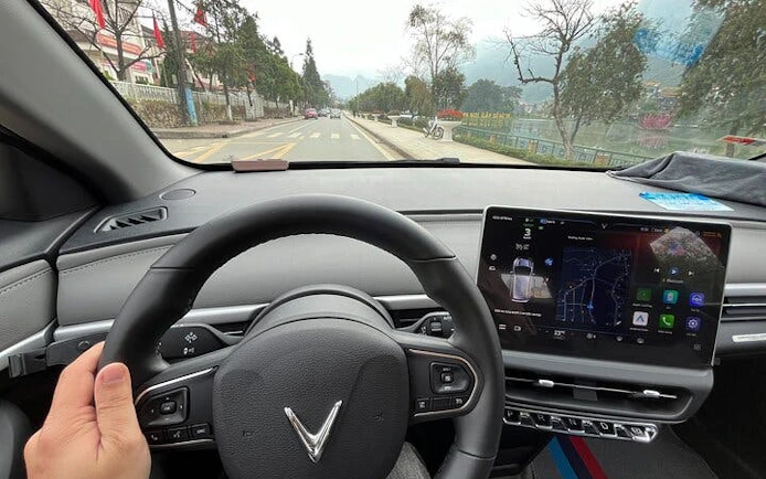 Private car interior on route from Sapa to Ha Giang City with local driver insights.