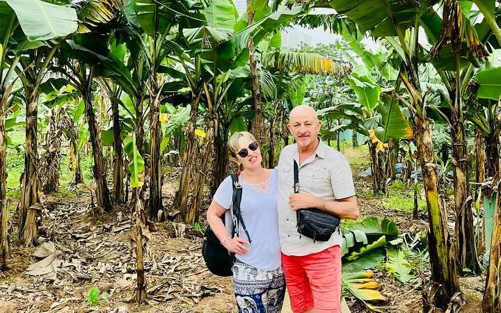 Couple exploring banana plantation on Hanoi countryside Vespa tour.