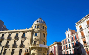 Granada cityscape with historic buildings under clear blue sky.